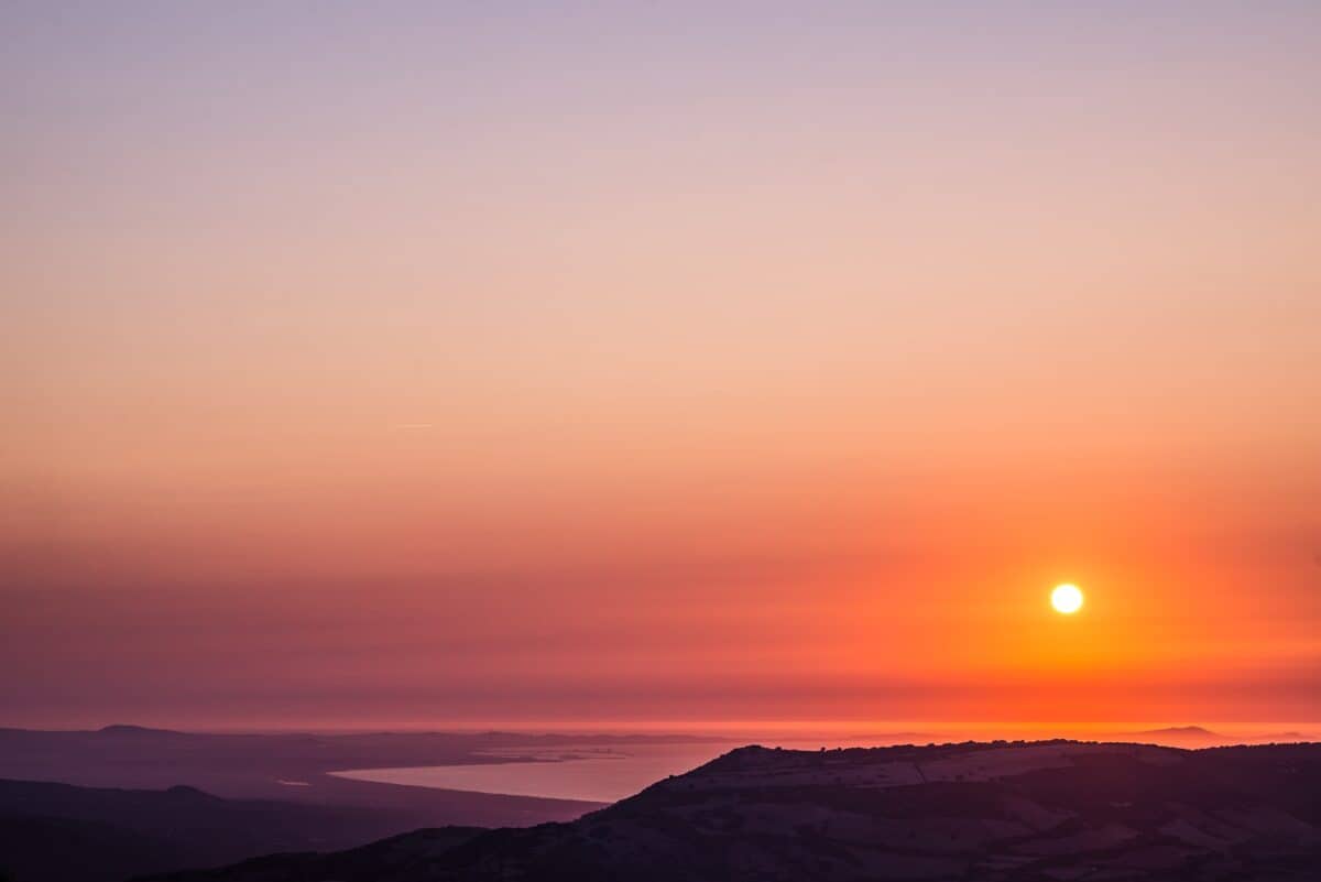 Orange sunset over ocean, Castelsardo, Sardinia, Italy