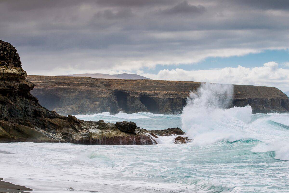 Waves crashing on rocky cliffs