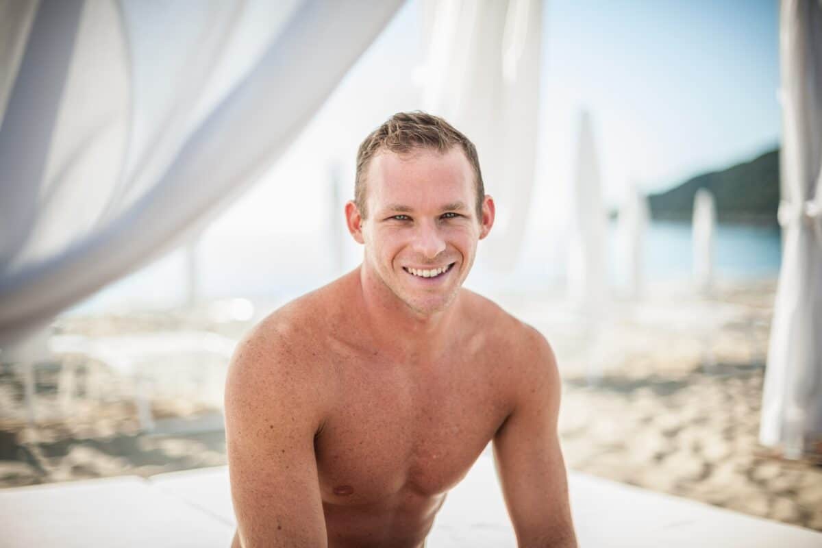 Portrait of young man on beach, Castiadas, Sardinia, Italy