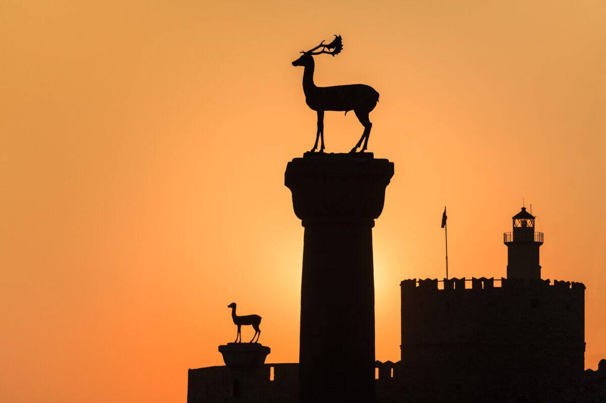 sunrise in Mandraki harbor. Rhodes, Greece